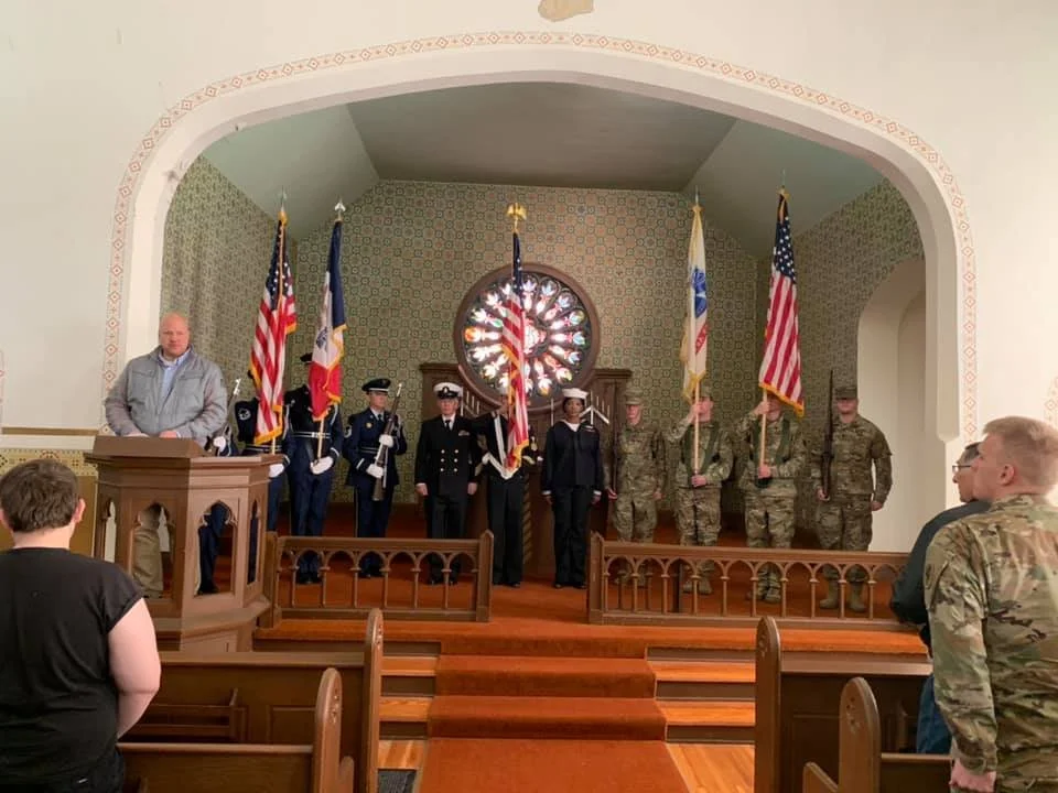 Color guards present flags at a past Massing of the Colors ceremony inside the Fort Des Moines Museum chapel.